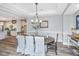 Inviting dining space with wood floors, large table and chairs, and view of the open-concept kitchen at 292 Lotz Dr, Summerville, SC 29483
