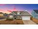 Charming single-Gathering home featuring stone accents and a welcoming front porch at sunset at 292 Lotz Dr, Summerville, SC 29483