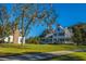 Classic two-story home with white siding, a welcoming porch, and a well-manicured lawn in a serene setting at 292 Lotz Dr, Summerville, SC 29483