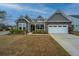 Attractive home featuring stone and gray shingle siding, attached garage and a front porch at 292 Lotz Dr, Summerville, SC 29483