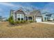 Charming home with stone accents, gabled roof, covered porch, and a white garage door at 292 Lotz Dr, Summerville, SC 29483