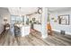 Modern kitchen featuring an island with seating, granite countertops, stainless steel appliances, and wood flooring at 292 Lotz Dr, Summerville, SC 29483