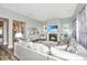 Bright living room features a fireplace, large sectional, and beach views on the television at 292 Lotz Dr, Summerville, SC 29483