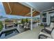 Spacious covered patio overlooking a pond with a fountain and several seating areas at 292 Lotz Dr, Summerville, SC 29483