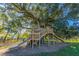 Custom treehouse featuring multiple levels, a slide, and sturdy construction, perfect for outdoor adventures at 292 Lotz Dr, Summerville, SC 29483