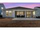 Back exterior with screened porch including seating and view to the back of the property at 302 Autumn Azalea Way, Summerville, SC 29486