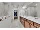 Bathroom with double vanity, large mirror, and a view into the walk-in closet at 302 Autumn Azalea Way, Summerville, SC 29486