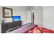 Bright bedroom featuring black dresser with TV, and a red bedspread, creating a cozy, inviting space at 302 Autumn Azalea Way, Summerville, SC 29486