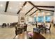 Community room with tables, seating, and fireplace at Latitude Margaritaville Watersound at 302 Autumn Azalea Way, Summerville, SC 29486