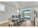 Dining room with a wooden table, bench seating, and an open door to the outside, perfect for gatherings at 302 Autumn Azalea Way, Summerville, SC 29486