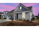 Inviting single-story home featuring a two-car garage and manicured landscaping at 302 Autumn Azalea Way, Summerville, SC 29486