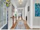 Light and inviting hallway with hardwood floors and decorative accents at 302 Autumn Azalea Way, Summerville, SC 29486