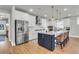 Modern kitchen featuring white cabinets, stainless steel appliances, and a spacious island at 302 Autumn Azalea Way, Summerville, SC 29486