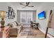 Bright living room featuring wood floors, a comfortable couch, and a dedicated workspace at 302 Autumn Azalea Way, Summerville, SC 29486