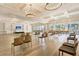 Large, open meeting room with rows of seating, a stage, and doors leading to an outside seating area at 302 Autumn Azalea Way, Summerville, SC 29486