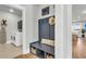 Mudroom featuring a bench with storage, coat hooks, and access to laundry room and living area at 302 Autumn Azalea Way, Summerville, SC 29486