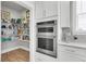 Walk-in pantry with wire shelving and adjacent stainless steel oven, offering ample storage and convenience at 302 Autumn Azalea Way, Summerville, SC 29486