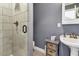 Bathroom featuring a glass shower, gray vanity with basket storage, and a round sink at 308 Jungle Rd, Edisto Beach, SC 29438