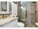 Bathroom featuring a glass-enclosed shower with gray tile and a white vanity with granite countertop at 308 Jungle Rd, Edisto Beach, SC 29438
