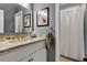 Bathroom with granite countertop, white cabinets and framed art at 308 Jungle Rd, Edisto Beach, SC 29438