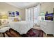 Comfortable bedroom with a queen-sized bed, dresser, and decorative lamps offering a warm ambiance at 308 Jungle Rd, Edisto Beach, SC 29438