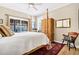 Bright bedroom with four-poster bed, hardwood floors and window views at 308 Jungle Rd, Edisto Beach, SC 29438