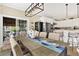 Open concept dining area with a large table and seamless access to a patio and the modern kitchen at 308 Jungle Rd, Edisto Beach, SC 29438