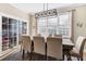 Dining room with modern light fixture, large windows, and sliding door access to outdoor space at 308 Jungle Rd, Edisto Beach, SC 29438