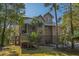 Beautiful two-story home with metal roof, manicured lawn, and mature trees, offering classic elegance at 308 Jungle Rd, Edisto Beach, SC 29438