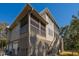 Exterior of house features a screened porch, garage, wood siding, and stairs at 308 Jungle Rd, Edisto Beach, SC 29438