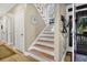 Entryway with staircase, hardwood floors, and natural light from a large window above the landing at 308 Jungle Rd, Edisto Beach, SC 29438