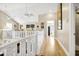 Hallway with hardwood floors and white banister at 308 Jungle Rd, Edisto Beach, SC 29438