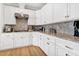 Kitchen featuring white cabinets, granite countertops, stainless steel appliances, and hardwood floors at 308 Jungle Rd, Edisto Beach, SC 29438