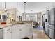 Bright kitchen with stainless steel appliances, granite countertops, and an adjacent dining area at 308 Jungle Rd, Edisto Beach, SC 29438