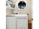 Laundry room with modern washer and dryer, bright lighting, and ample storage space at 308 Jungle Rd, Edisto Beach, SC 29438