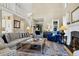 Bright living room with a soaring ceiling, comfortable seating, and elegant staircase at 308 Jungle Rd, Edisto Beach, SC 29438