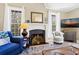Well-lit living room with a fireplace, plush armchairs, and large windows offering ample light at 308 Jungle Rd, Edisto Beach, SC 29438