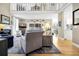 Inviting living room featuring a fireplace, large windows, and stylish decor at 308 Jungle Rd, Edisto Beach, SC 29438