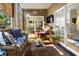 Cozy sunroom porch with wicker furniture, wood floors, and serene outdoor views at 308 Jungle Rd, Edisto Beach, SC 29438