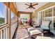 Covered porch with two red chairs and a couch at 308 Jungle Rd, Edisto Beach, SC 29438