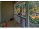 A porch area with a view of the surrounding trees and a nearby road at 308 Jungle Rd, Edisto Beach, SC 29438