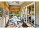 Relaxing screened porch with wicker furniture, offering a peaceful outdoor living space at 308 Jungle Rd, Edisto Beach, SC 29438