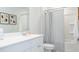Bright bathroom features a shower-tub combo, framed art, and a sink with white cabinetry at 317 Pine Crest View, Summerville, SC 29486