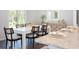 Dining room with a white table, black chairs, and a stylish wooden buffet at 317 Pine Crest View, Summerville, SC 29486