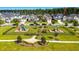 Aerial view of the playground with a large green space and beautiful homes in the background at 317 Pine Crest View, Summerville, SC 29486