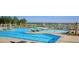Resort-style community pool featuring lounge chairs, tables, and splash pad, perfect for relaxation and Gathering fun at 317 Pine Crest View, Summerville, SC 29486