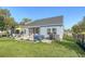 Spacious backyard with a hot tub, patio, and well-maintained lawn at 3278 Great Egret Dr, Johns Island, SC 29455