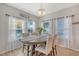 Inviting dining room featuring a wooden table, stylish chairs, a chandelier, and an abundance of natural light at 3278 Great Egret Dr, Johns Island, SC 29455