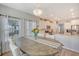 Bright dining room featuring a wood table, seating, a chandelier and adjoins the open kitchen at 3278 Great Egret Dr, Johns Island, SC 29455