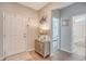 Bright entryway showcasing wood floors, stylish cabinet, with decorative accents leading to the bathroom and bedroom at 3278 Great Egret Dr, Johns Island, SC 29455